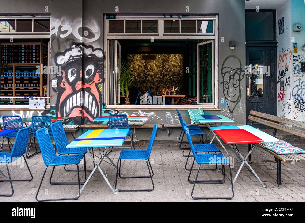 Nauta Peruvian Restaurant. Colourful graffiti-covered exterior with socially distanced oudoor tables during COVID-19 pandemic in Mitte Berlin Stock Photo