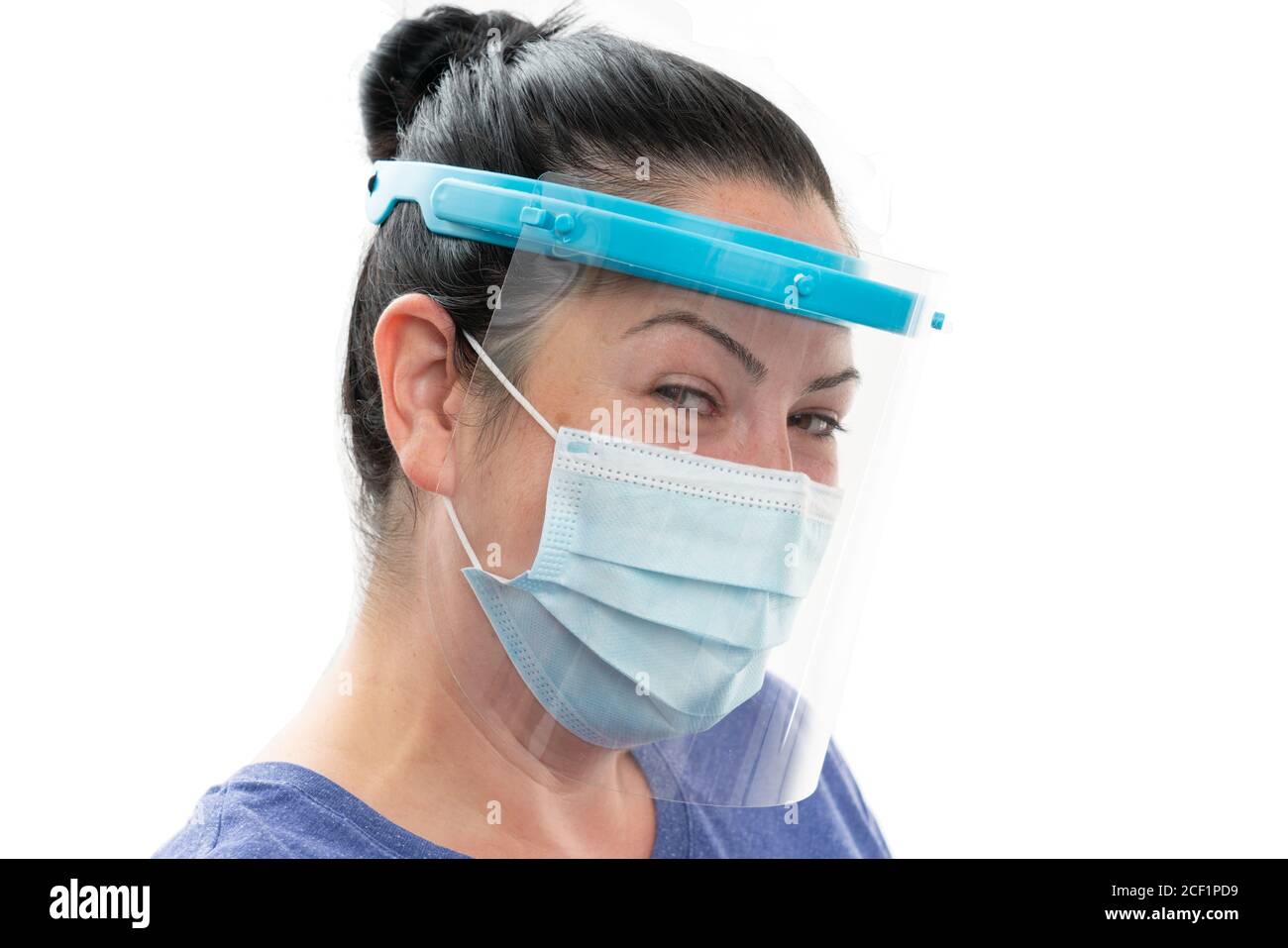 Happy adult woman wearing transparent face shield and medical or surgical disposable mask as covid sars flu pandemic virus protection isolated on whit Stock Photo