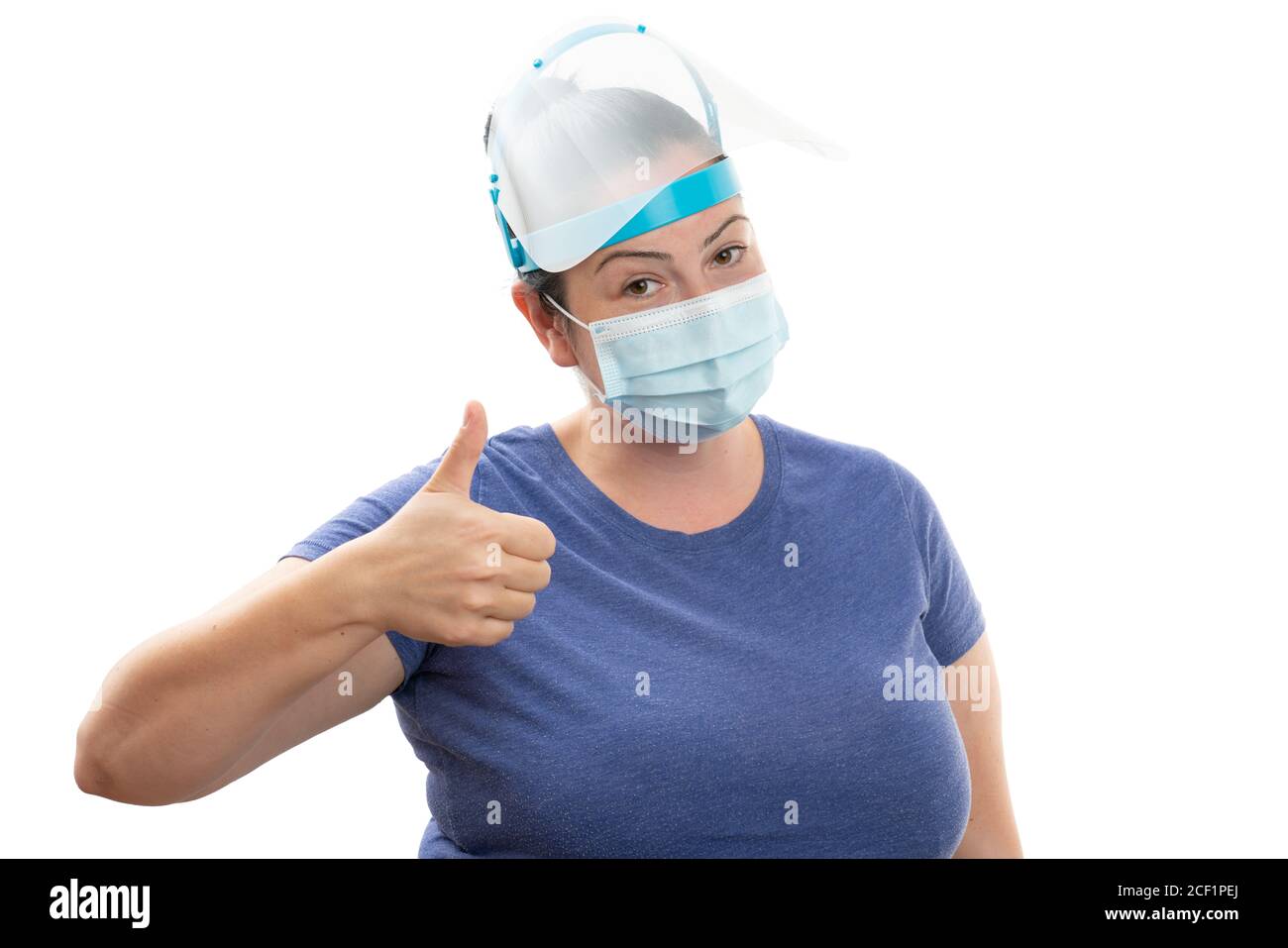 Adult woman wearing transparent face shield and disposable surgical or medical mask as covid19 influenza virus protection making like gesture with thu Stock Photo