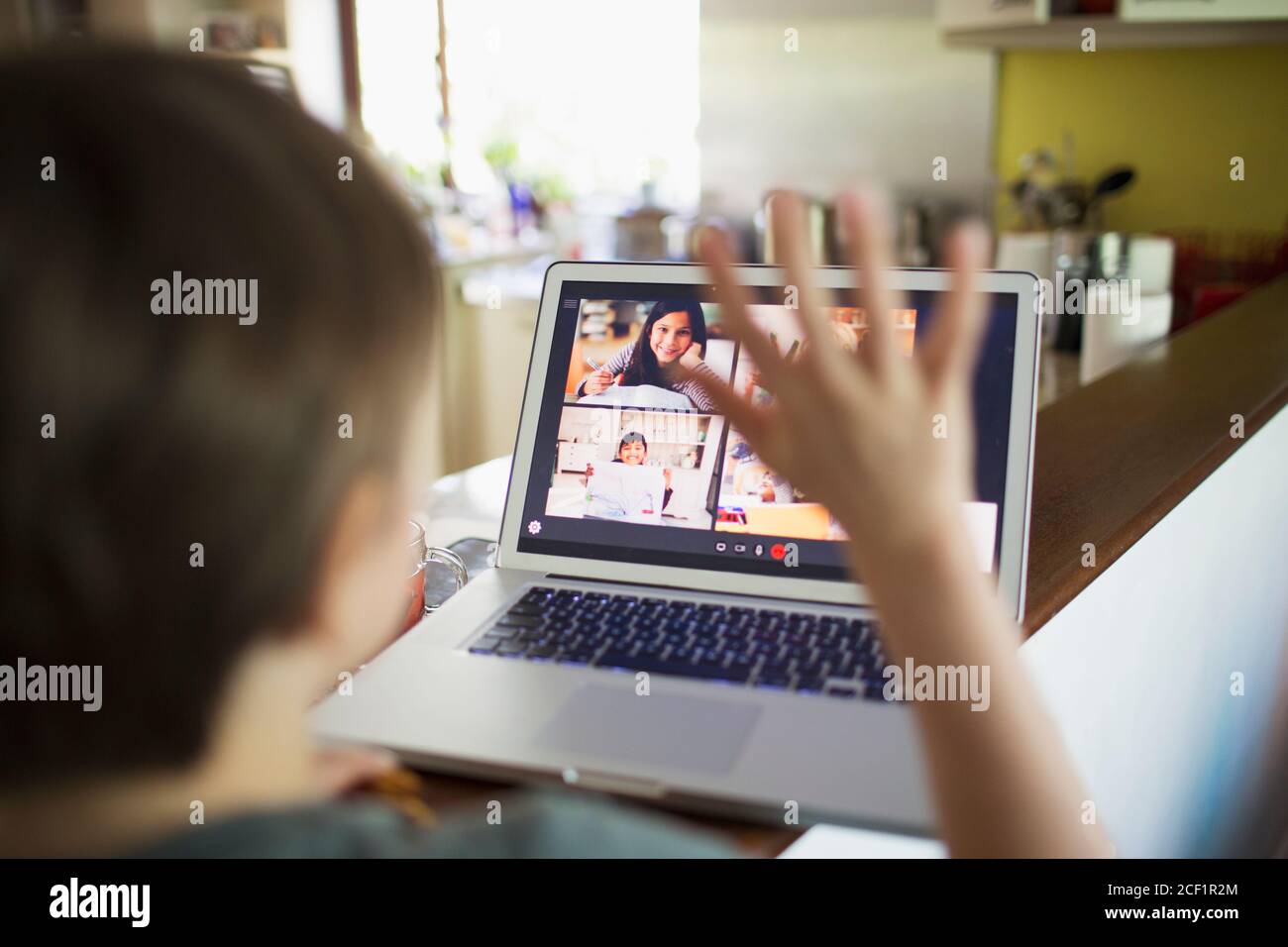 Boy e-learning video conferencing with classmates on laptop screen Stock Photo