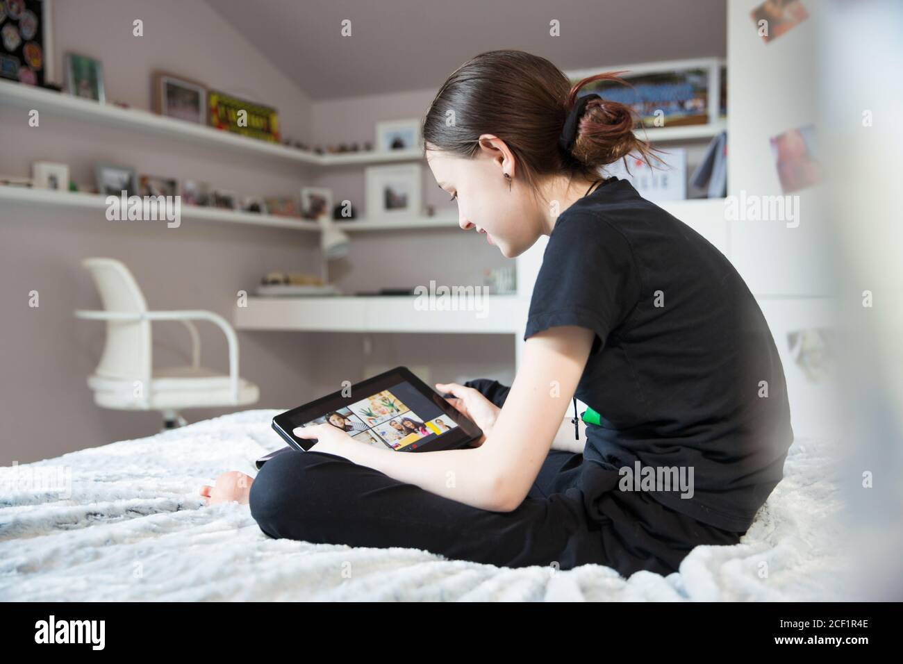Girl e-learning with digital tablet on bed Stock Photo