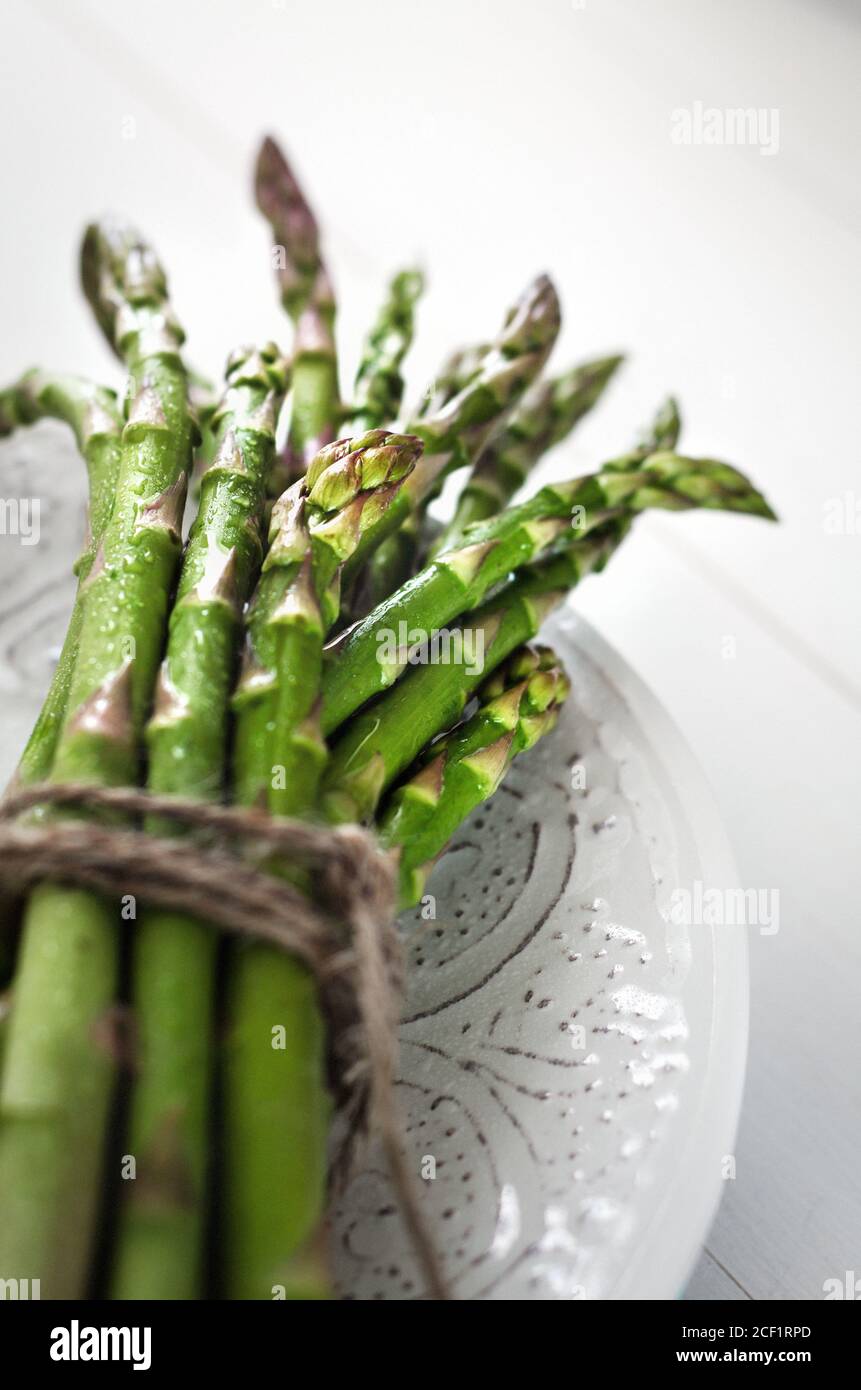 Close up bundled fresh green asparagus Stock Photo