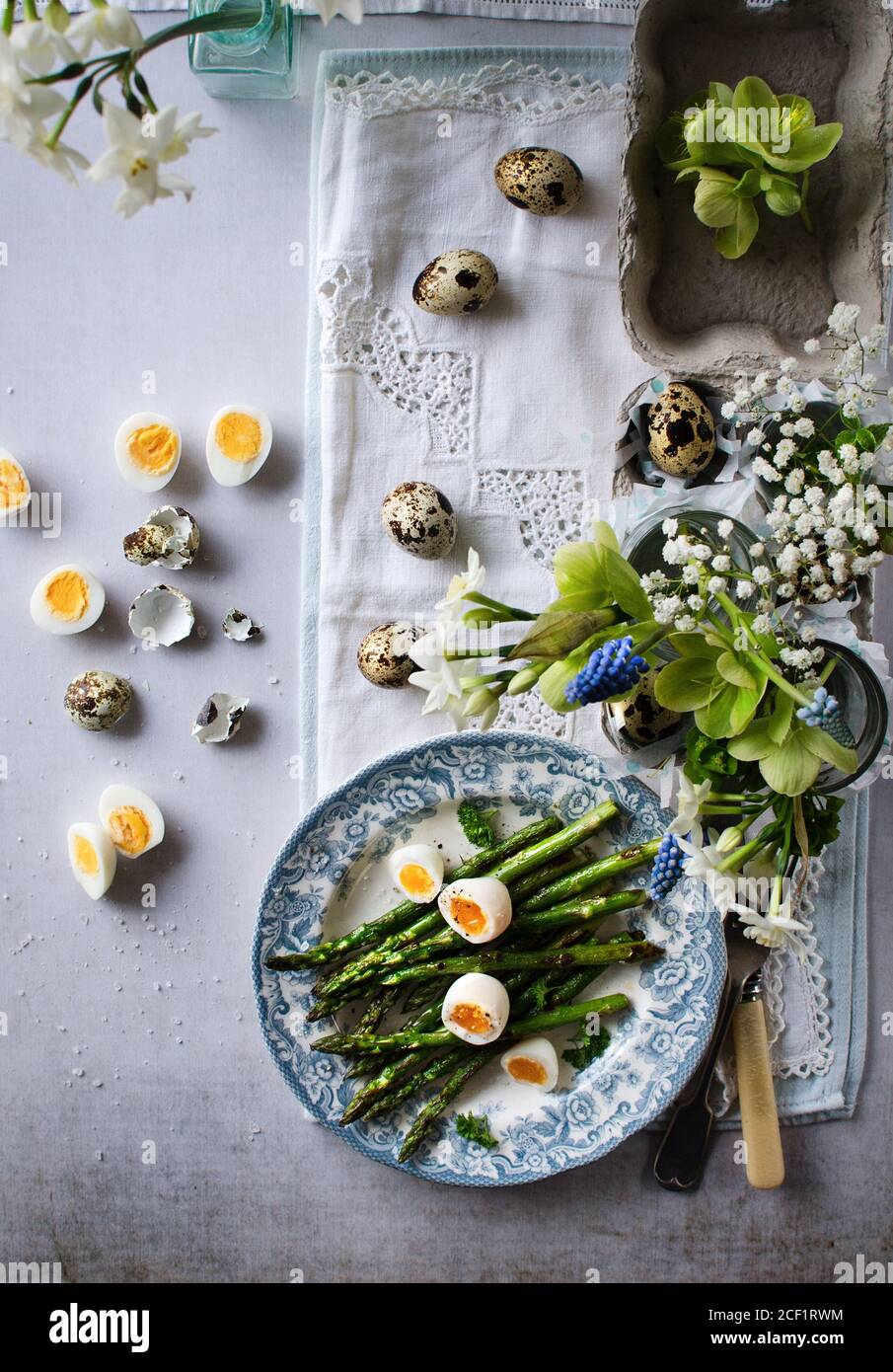 Asparagus and quail eggs on Easter table Stock Photo