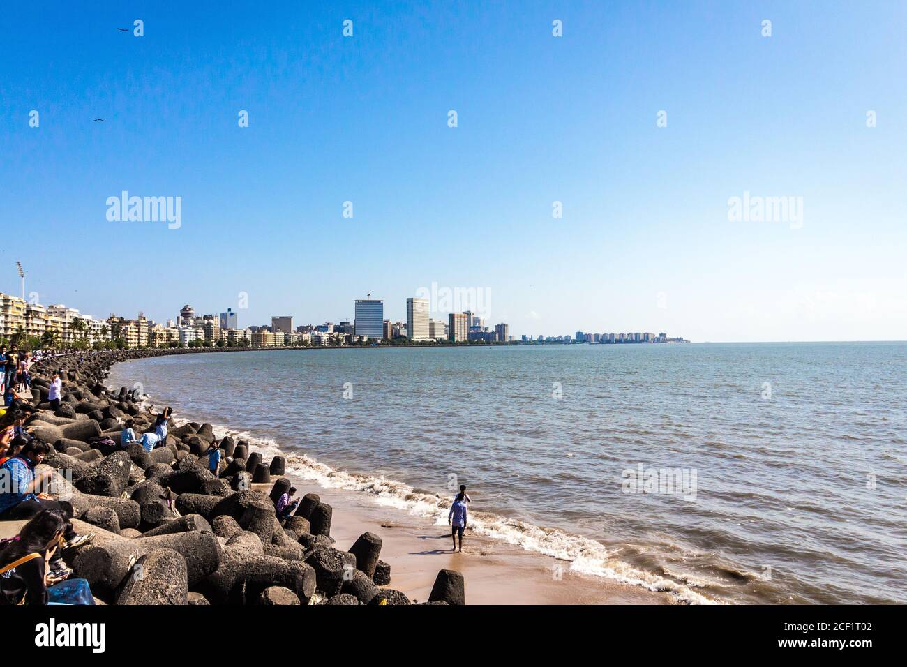 Marine Drive with locals and travellers enjoying the sun bathing at the Chowpatty beach. Marine Drive aka the Queen's necklace. Mumbai city Marine. Stock Photo