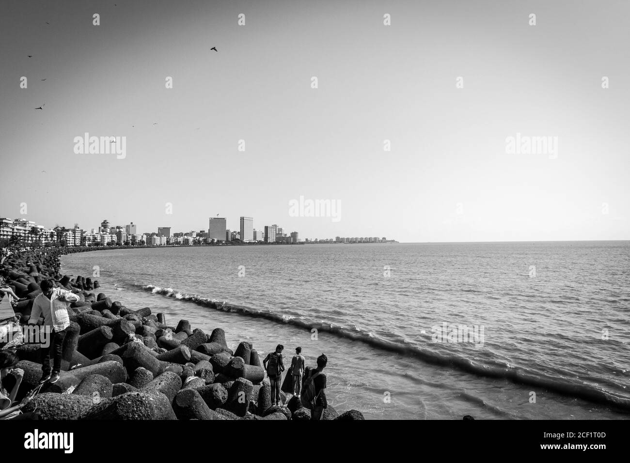 Marine Drive with locals and travellers enjoying the sun bathing at the Chowpatty beach. Marine Drive aka the Queen's necklace. Mumbai city Marine. Stock Photo