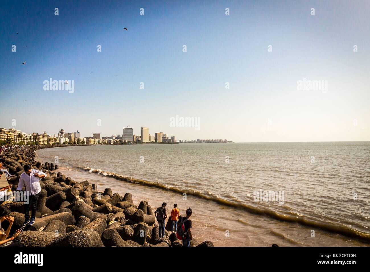 Marine Drive with locals and travellers enjoying the sun bathing at the Chowpatty beach. Marine Drive aka the Queen's necklace. Mumbai city Marine. Stock Photo