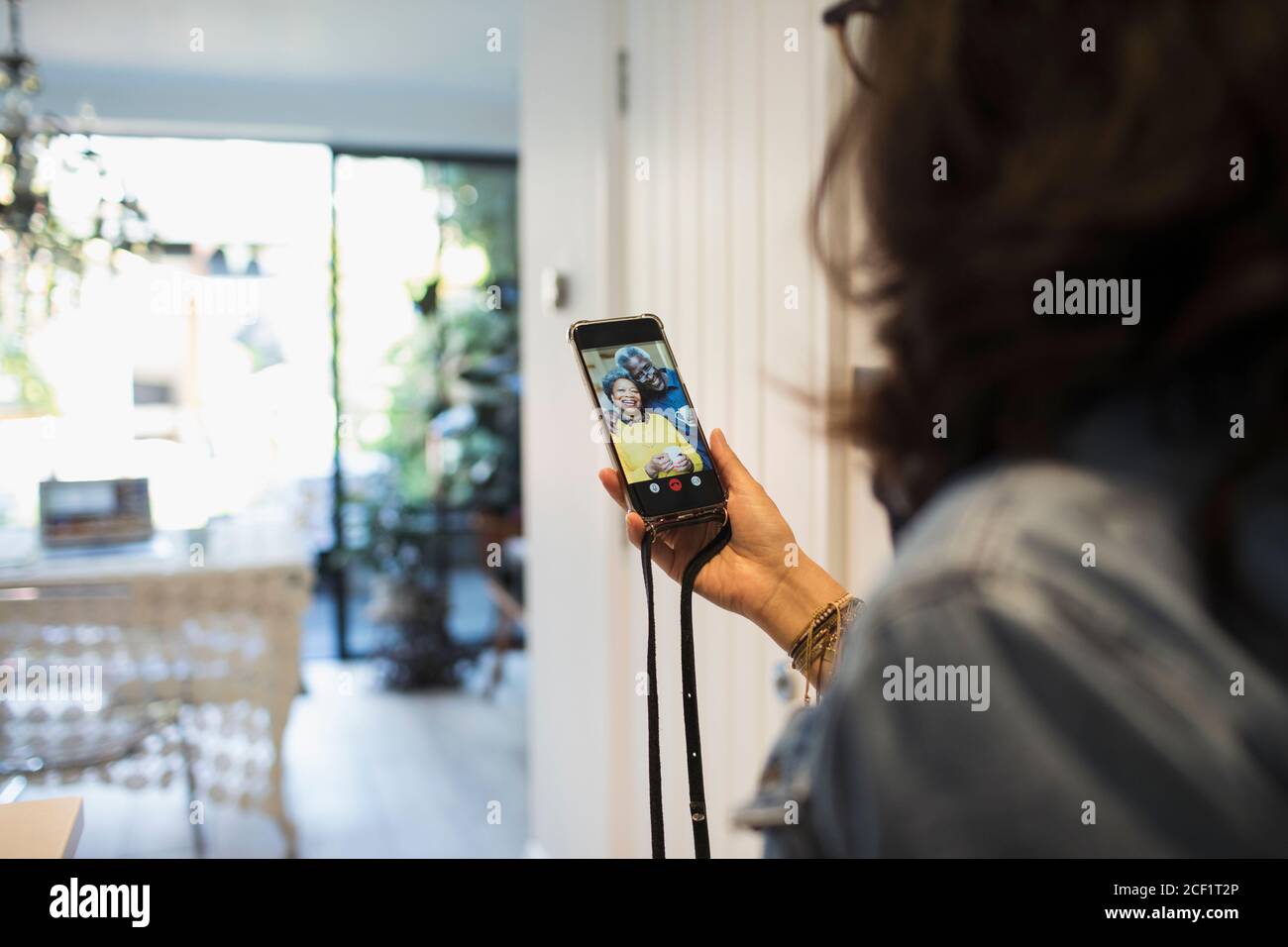 Woman video chatting with friends on smart phone screen Stock Photo