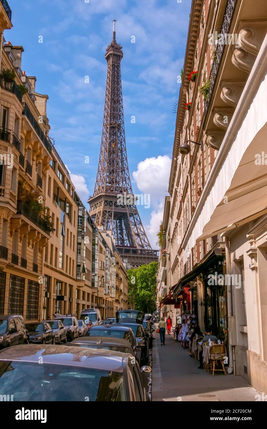 France. Paris. Narrow city street in summer sunny weather. The Eiffel Tower. Stock Photo