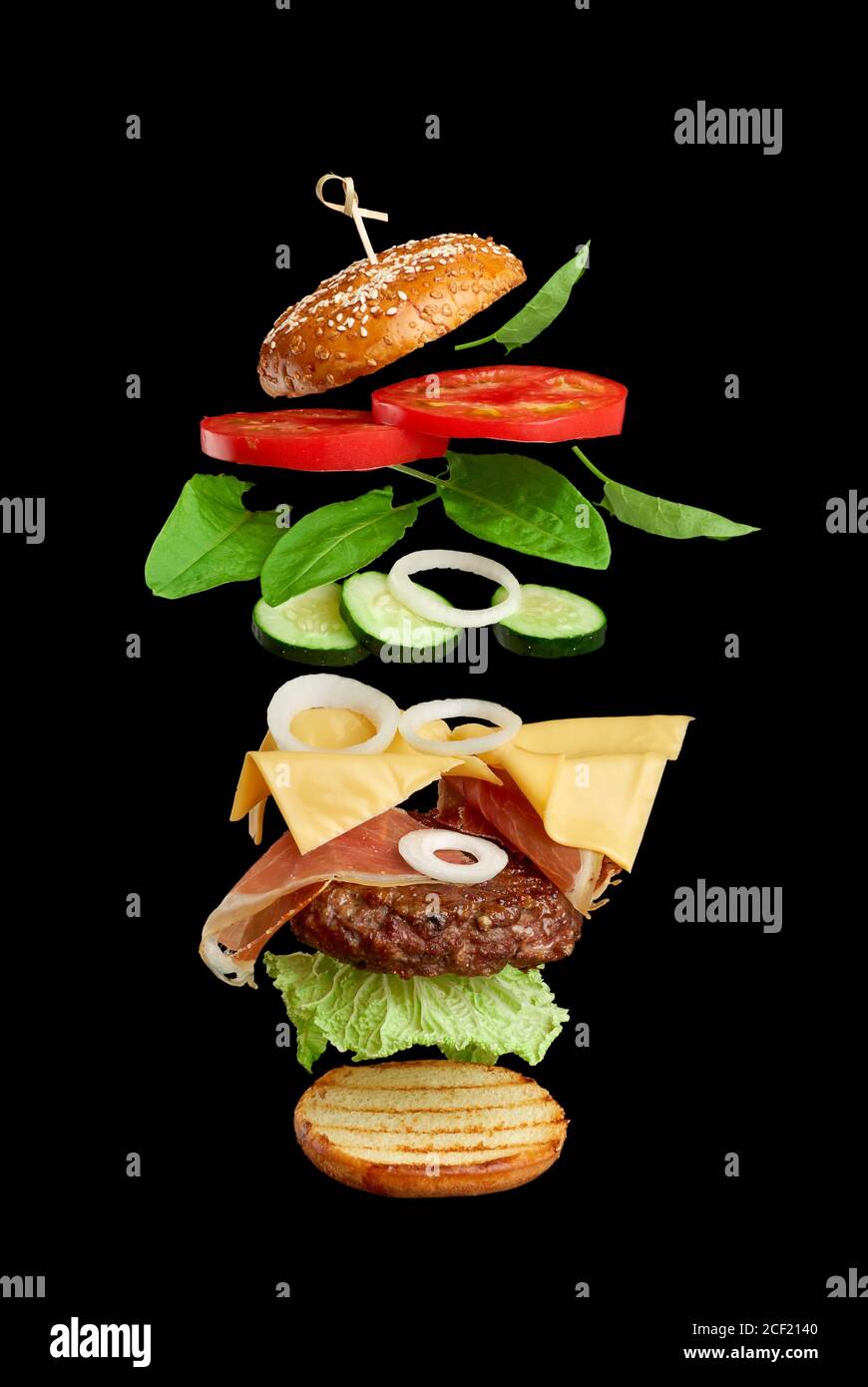flying burger ingredients cutlet, sesame seed bun, tomato, onion