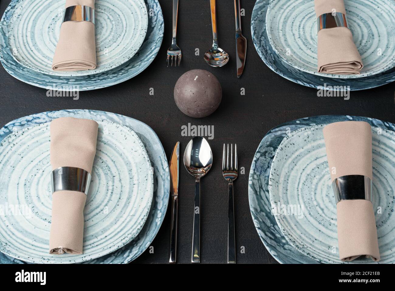 Table setting. Plates with abstract pattern on black table Stock Photo ...