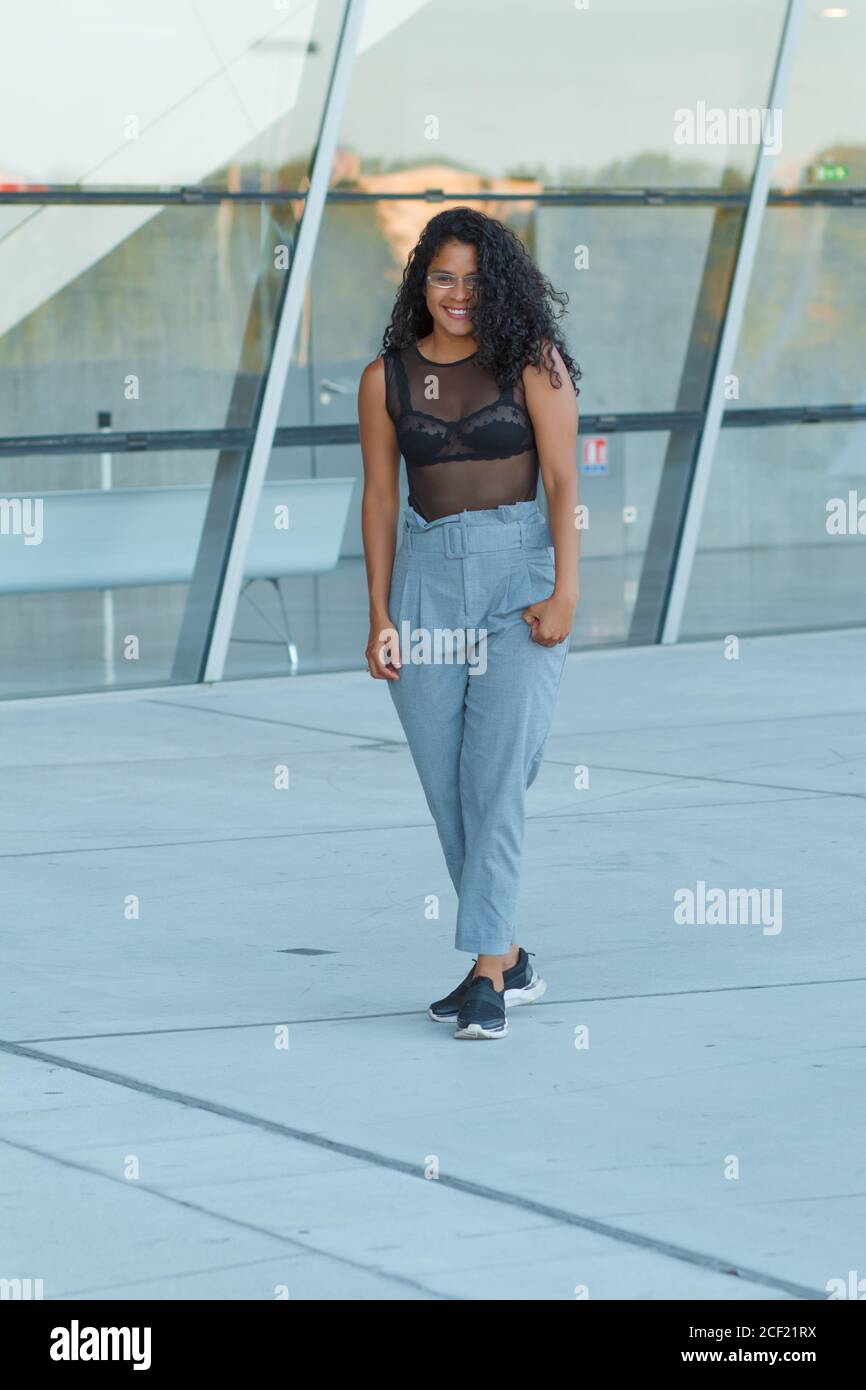 A curly brunette Hispanic female posing 