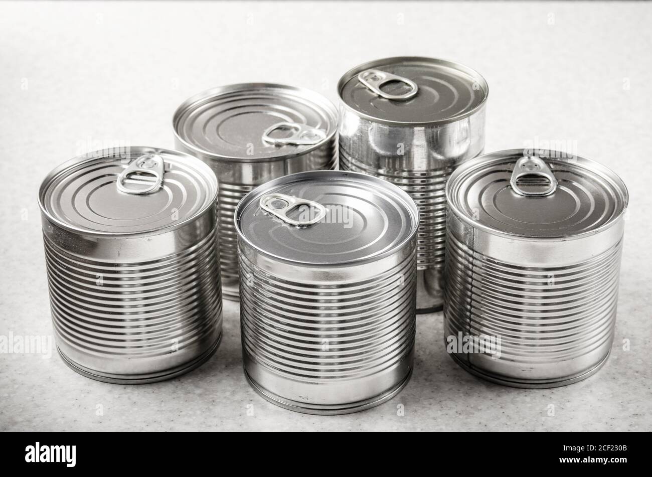 Set of various canned foods in tin cans on kitchen table, non