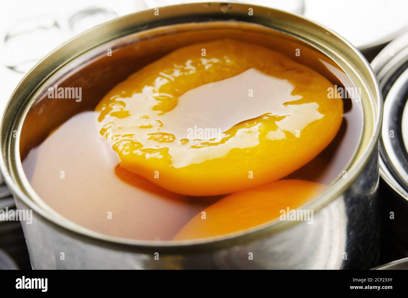 Canned peaches in just opened tin can. Non-perishable food Stock Photo ...