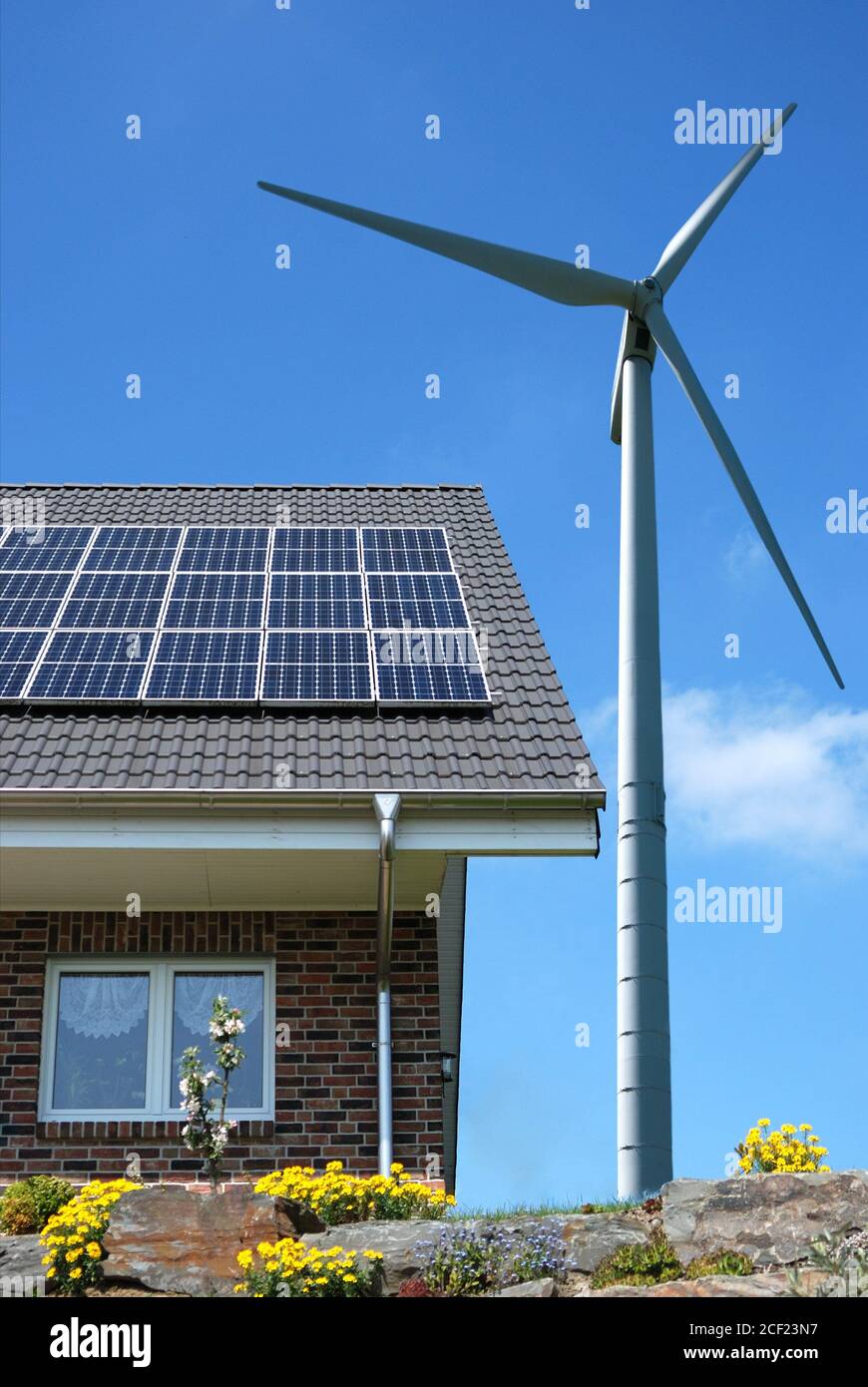 Roof with solar panels and wind turbines aside Stock Photo - Alamy