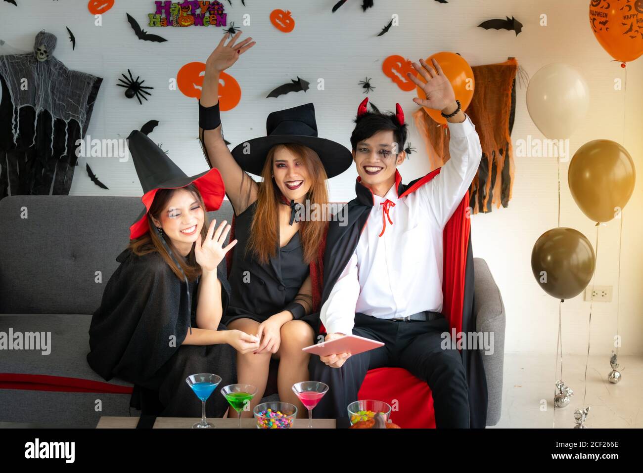 Group Of Young Adult And Teenager People Celebrating A Halloween Party Carnival Festival In Halloween Costumes With Food And Drink On Table Stock Photo Alamy