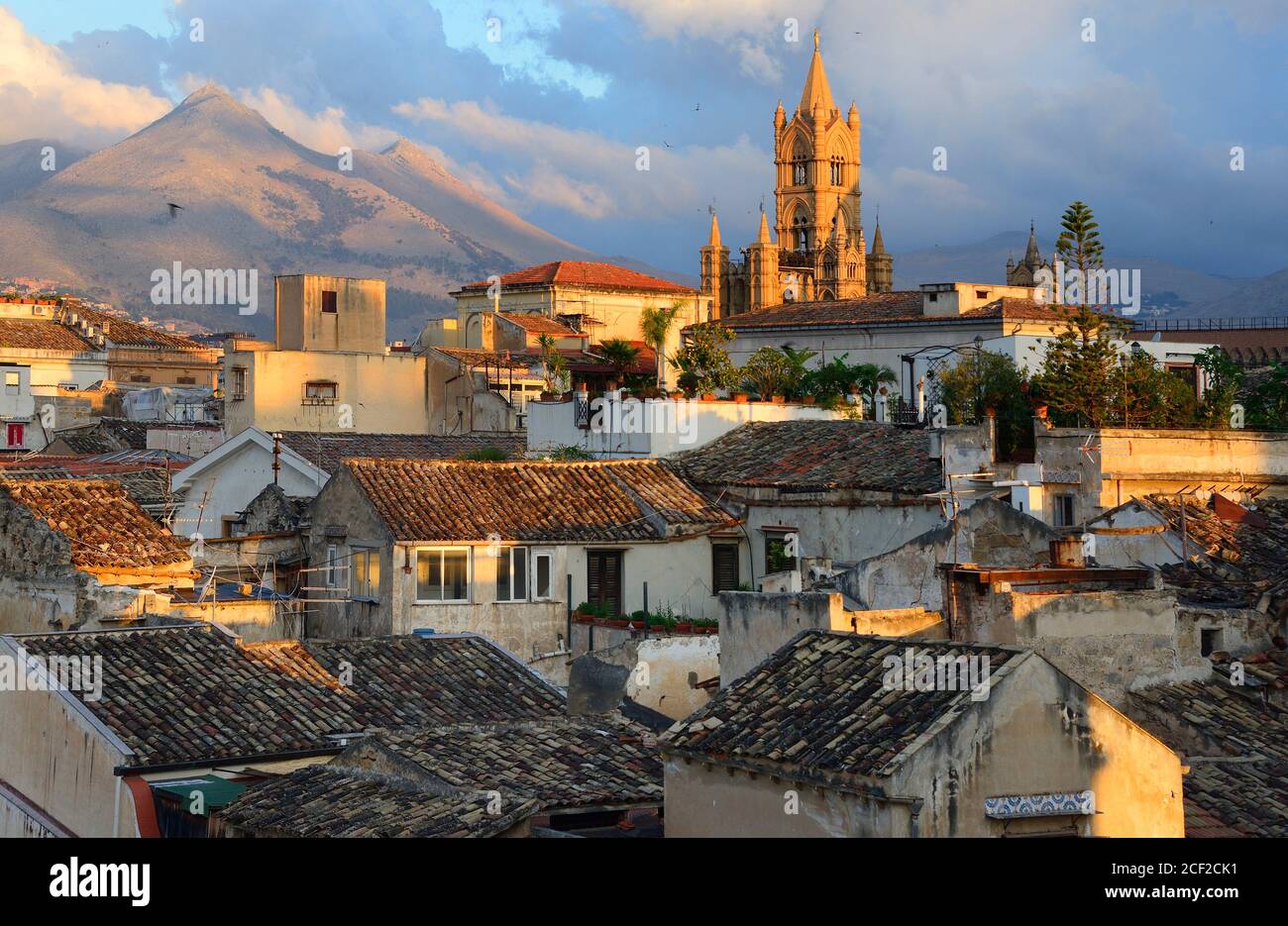 In foreground architecture of old town of Palermo, In background towers and Cupola of Roman Catholic Archdiocese of Palermo, Cathedral dedicated to Stock Photo
