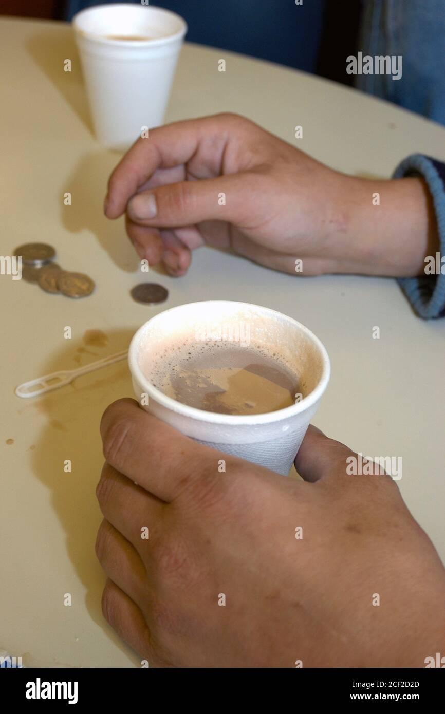 Homeless man drinking coffee at St Anne's drop in centre for homeless