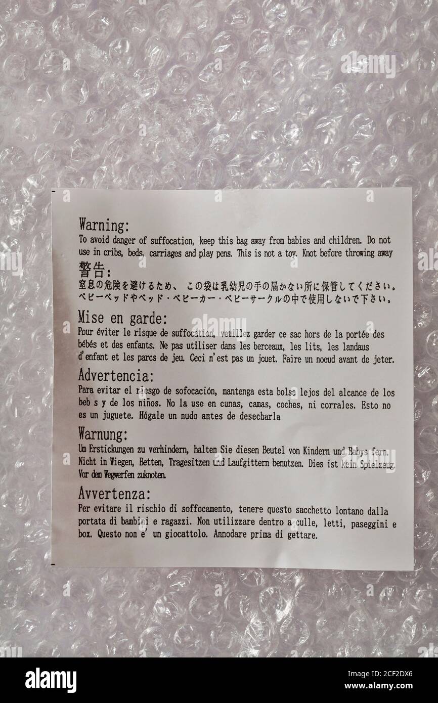 Warning to avoid danger of suffocation keep this bag away from babies and children - label on bubble wrap bag wrapping Stock Photo