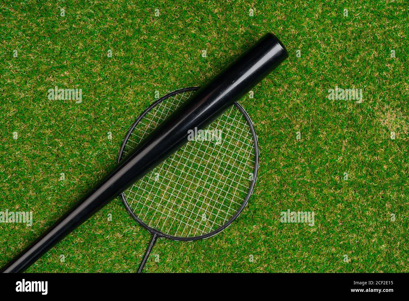 Baseball bat and badminton racket on grass, top view Stock Photo Alamy