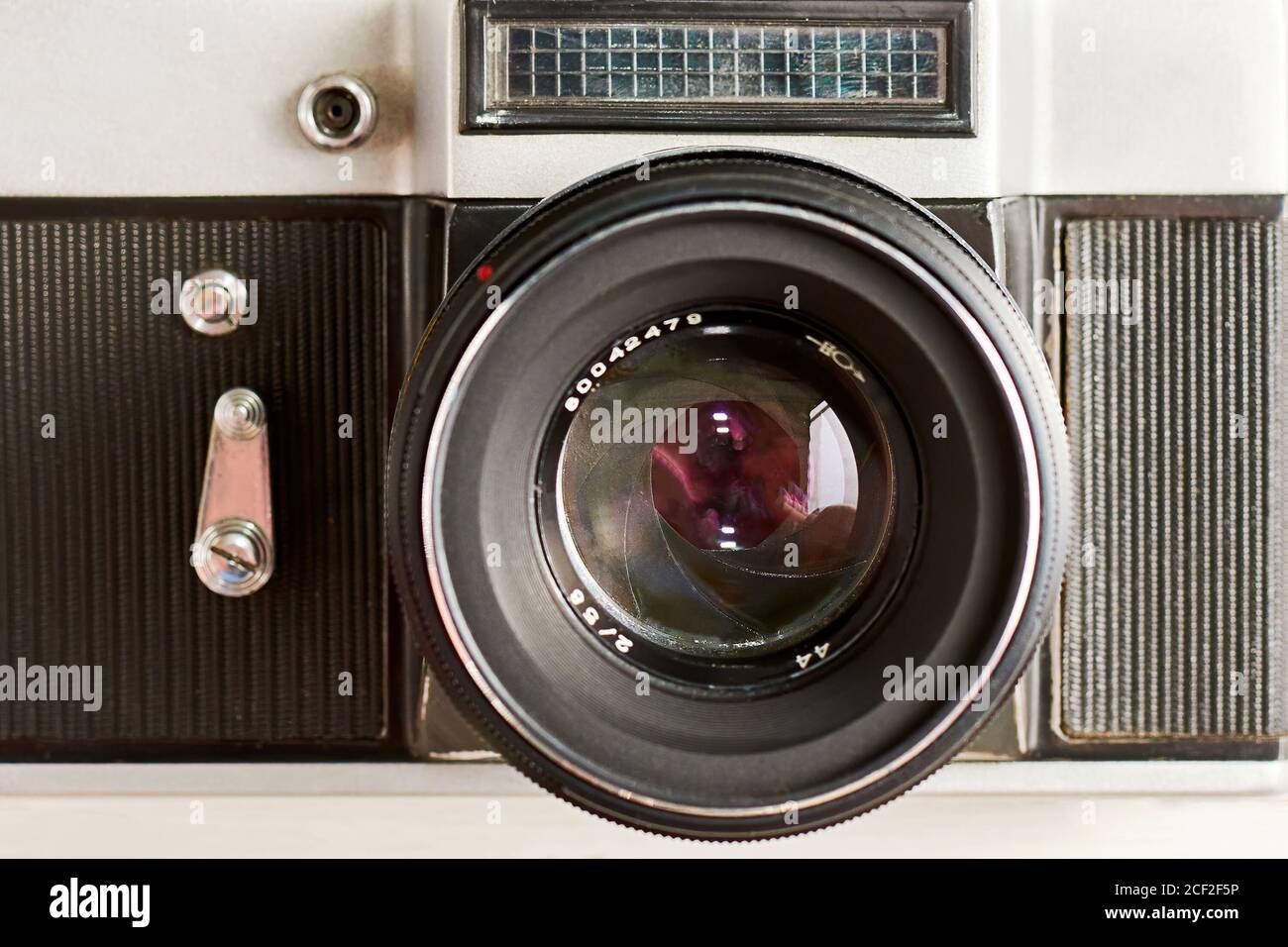Vintage photo camera with optical lens and aperture blades, front view as icon. Old retro devices backgrounds Stock Photo
