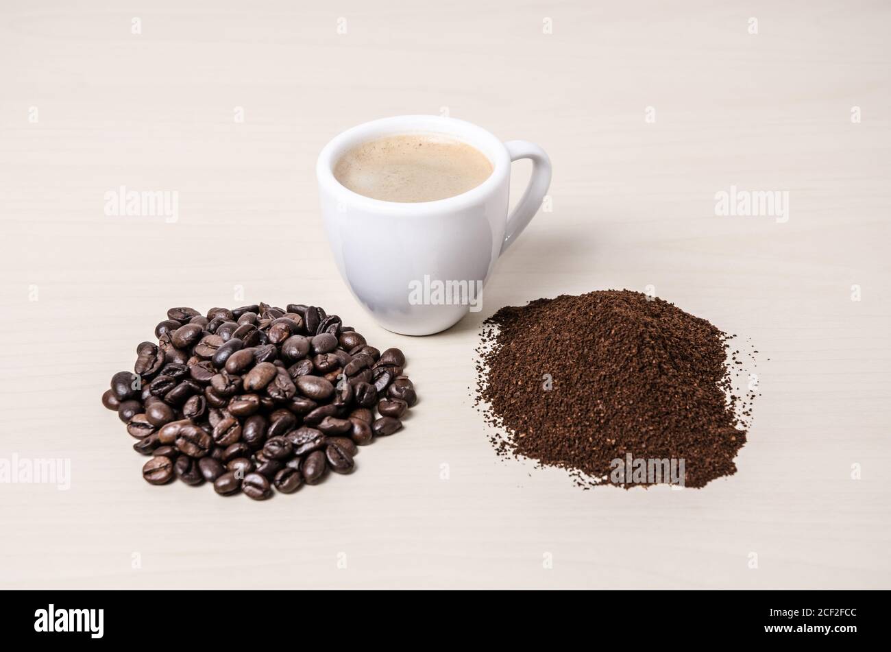 One coffee cup or mug with beans and ground coffee on wooden desk or table, I like, love coffee, close-up, coffee making concept Stock Photo