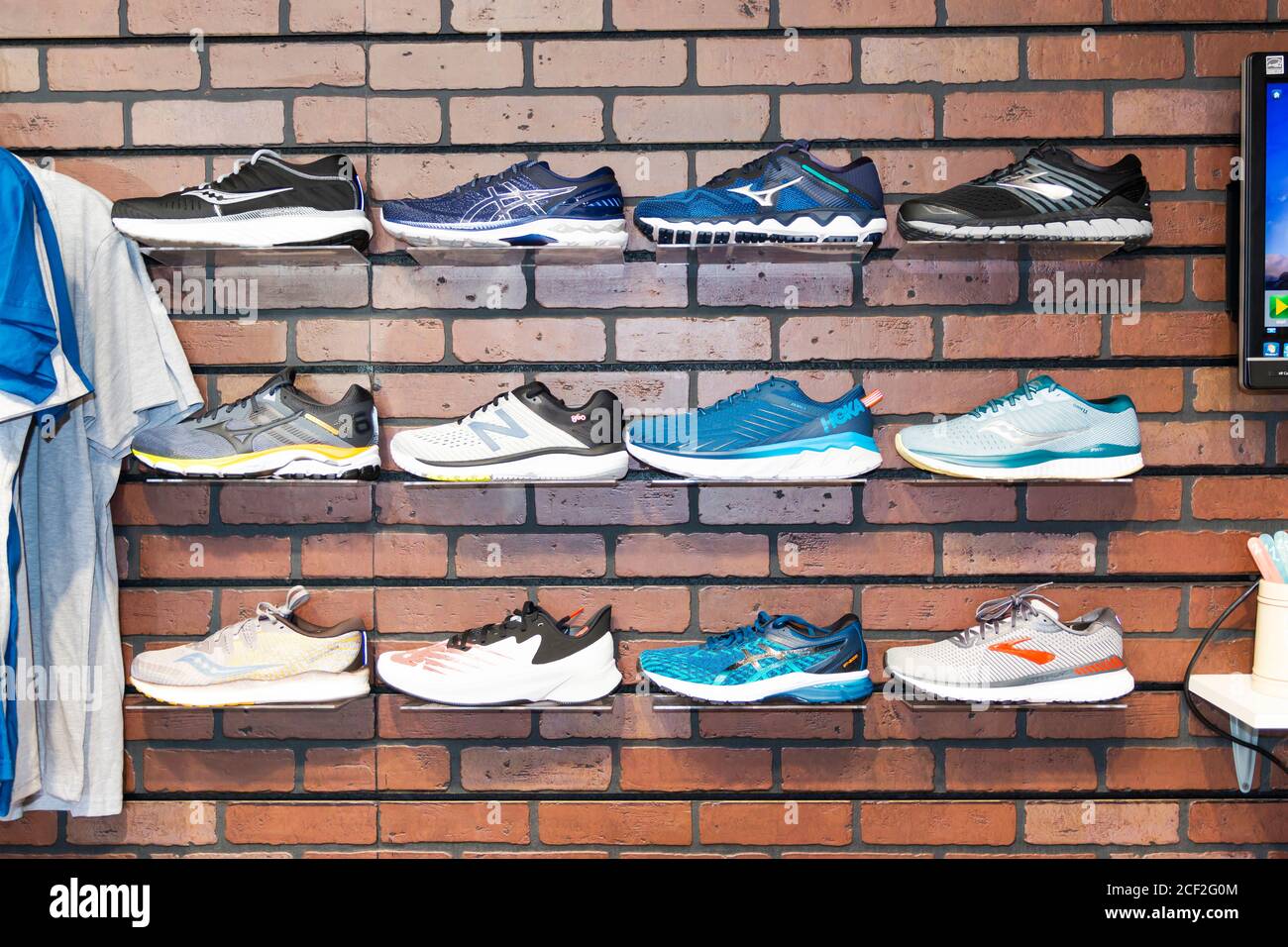 Smithtown, New York, USA - 28 August 2020: Running shoes are against the wall on display at a running shoe specialty store. Stock Photo