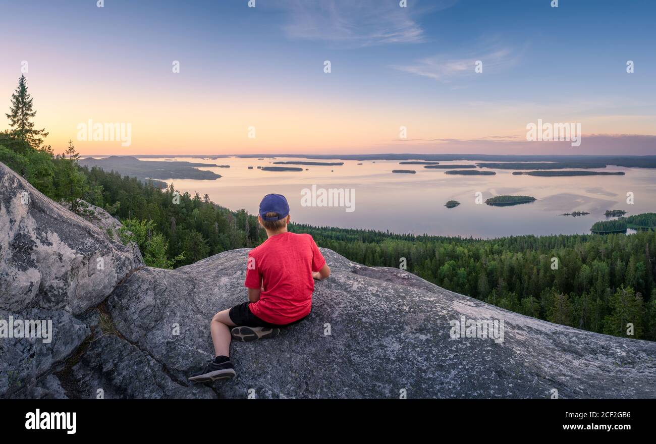 Scenic panorama landscape with lake, sunset and children at evening in Koli, national park, Finland Stock Photo