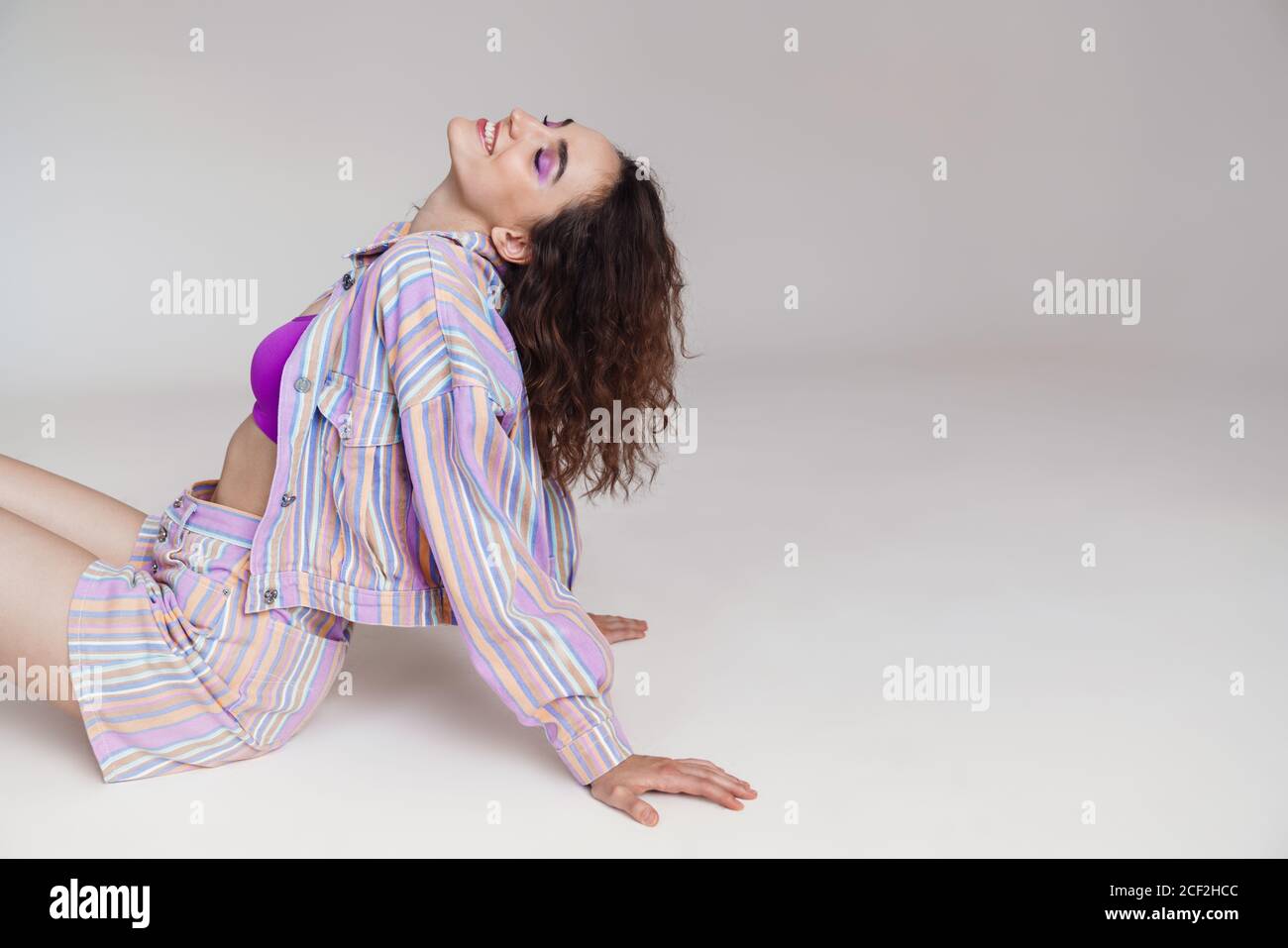 Image of ginger happy woman smiling while sitting on floor isolated ...