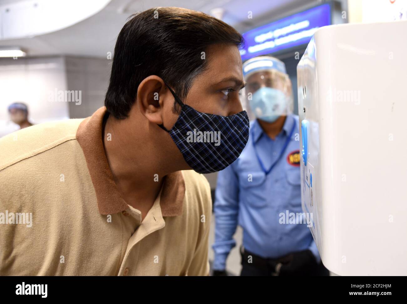 A person undergoing thermal test screening as the first step of testing against Covid-19 at a Metro station in New Delhi on Thursday September 03, 2020.  Metro services across India will resume in phases from September 07 to boost public transport facility with the backdrop of Covid-19 cases. There are 15 Metro networks across the country and about 2.7 million passengers used network daily before the pandemic. Photograph: Sondeep Shankar Stock Photo
