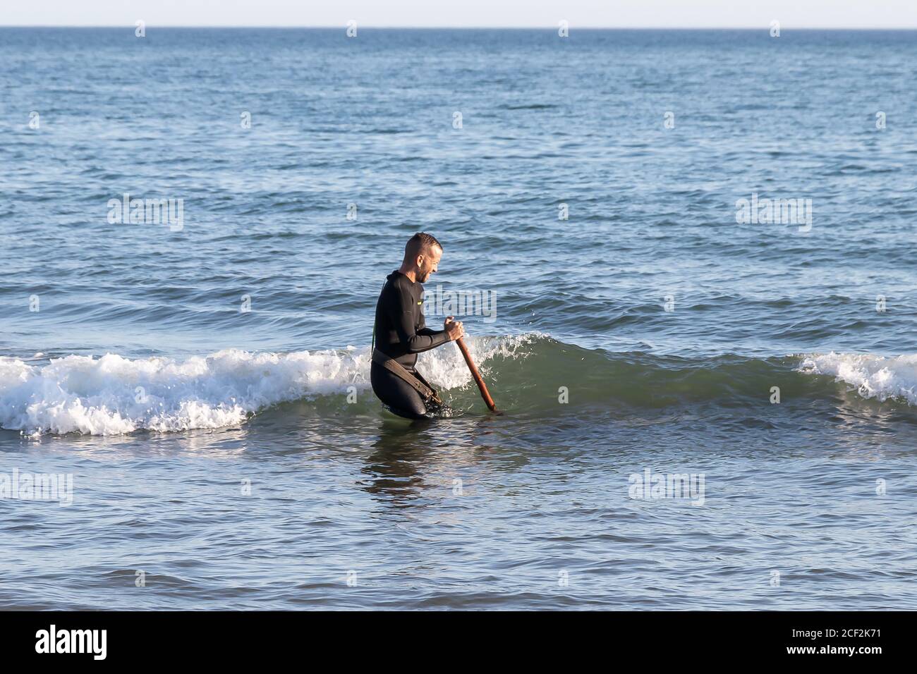 Punta Umbria, Huelva, Spain - August 31, 2020: Clam fisherman working on the seashore of Punta Umbria beach on the coast of Huelva, Andalusia region, Stock Photo