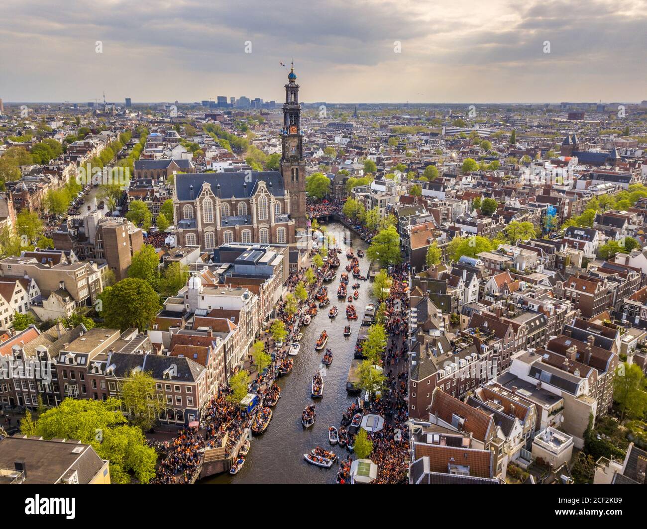 Amsterdam aerial view of Westerkerk church seen from north on Koningsdag Kings day festivities. Birthday of the king. Seen from helicopter. Stock Photo