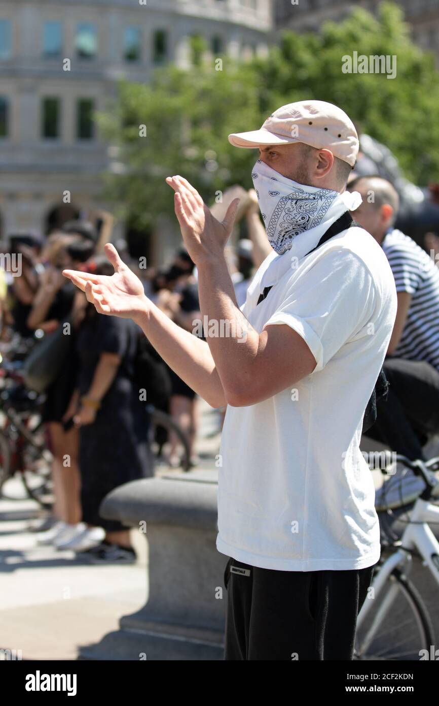 A white man wearing a bandana claps at a Black Lives Matter protest in  Trafalgar Square, London Stock Photo - Alamy