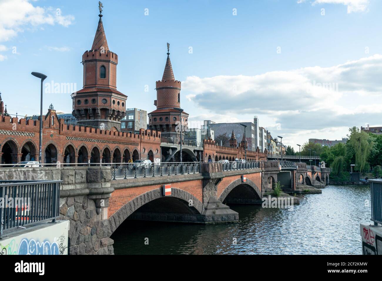 BERLIN, GERMANY - May 14, 2020: BERLIN, GERMANY May 14, 2020. The Oberbaum Bridge on the Spree with a blue sky and clouds. It connects Friedrichshain Stock Photo