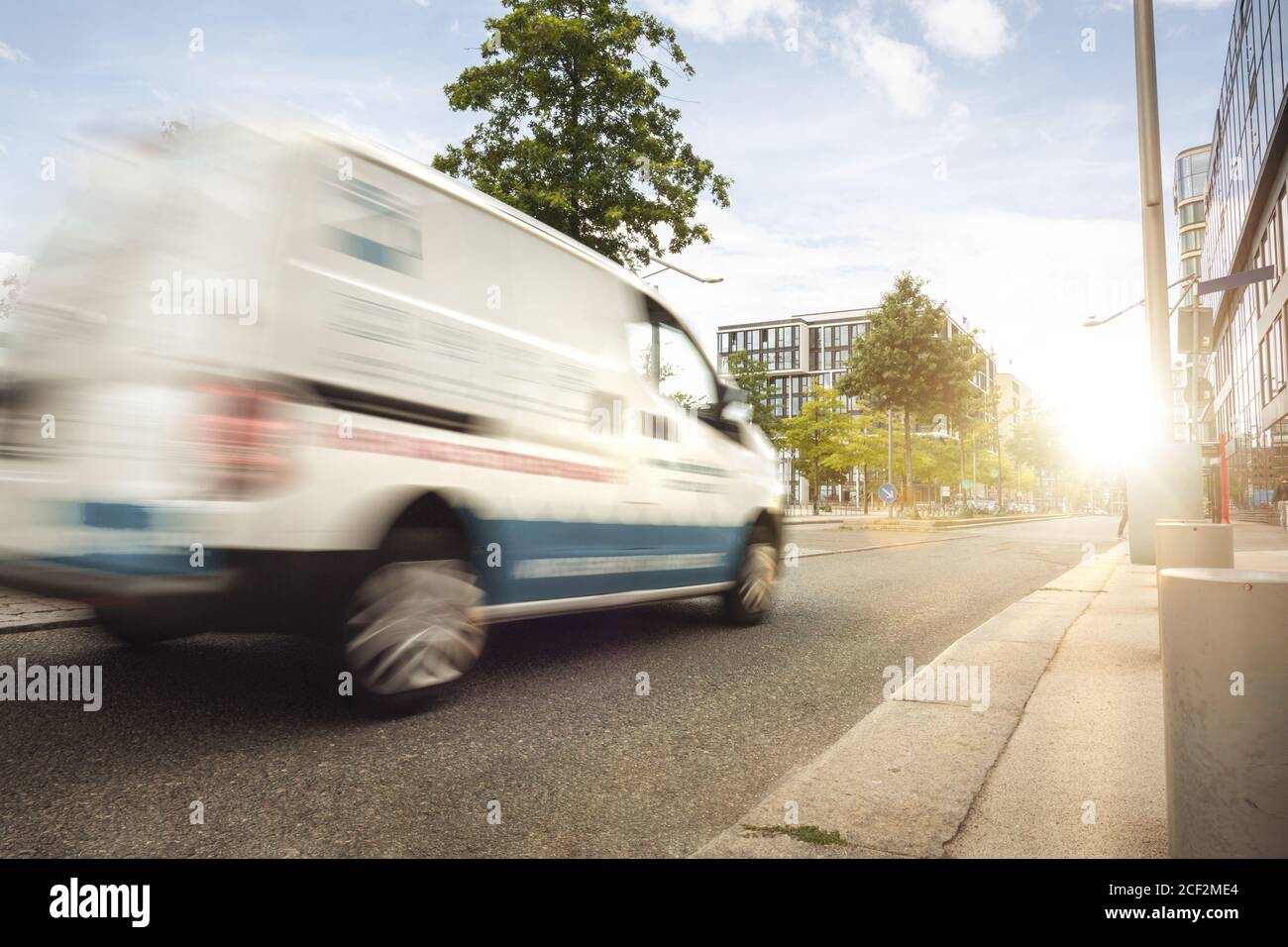 Fast service van driving through the city Stock Photo