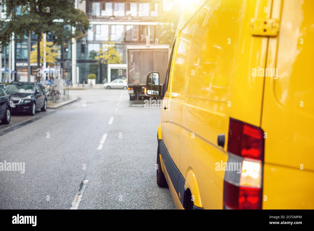 Delivery van on a street inside a city Stock Photo - Alamy