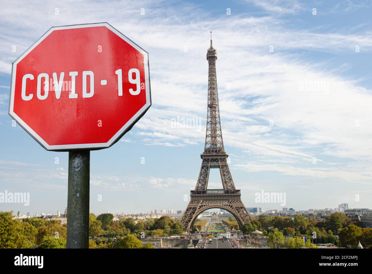 COVID-19 sign with Eiffel tower in Paris, France. Warning about pandemic in France. Coronavirus disease. COVID-2019 alert sign Stock Photo