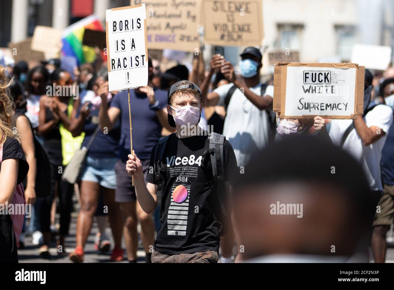 A white male protester holds a sign saying Boris is a Racist at a Black Lives Matter protest in Trafalgar Square, London Stock Photo