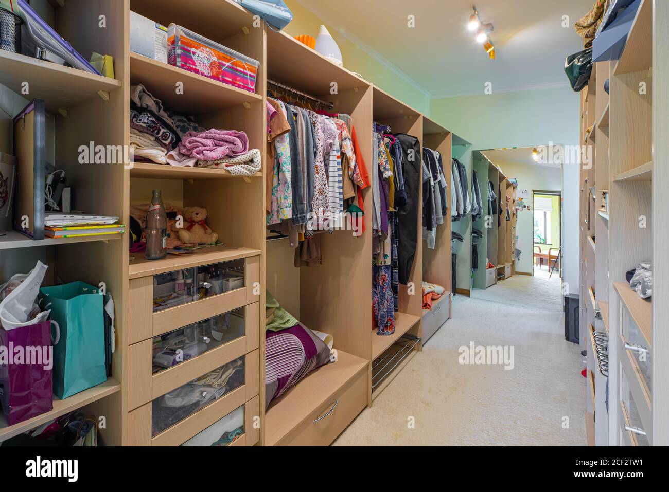 Modern interior of dressing room in luxury apartment. Full drawers and