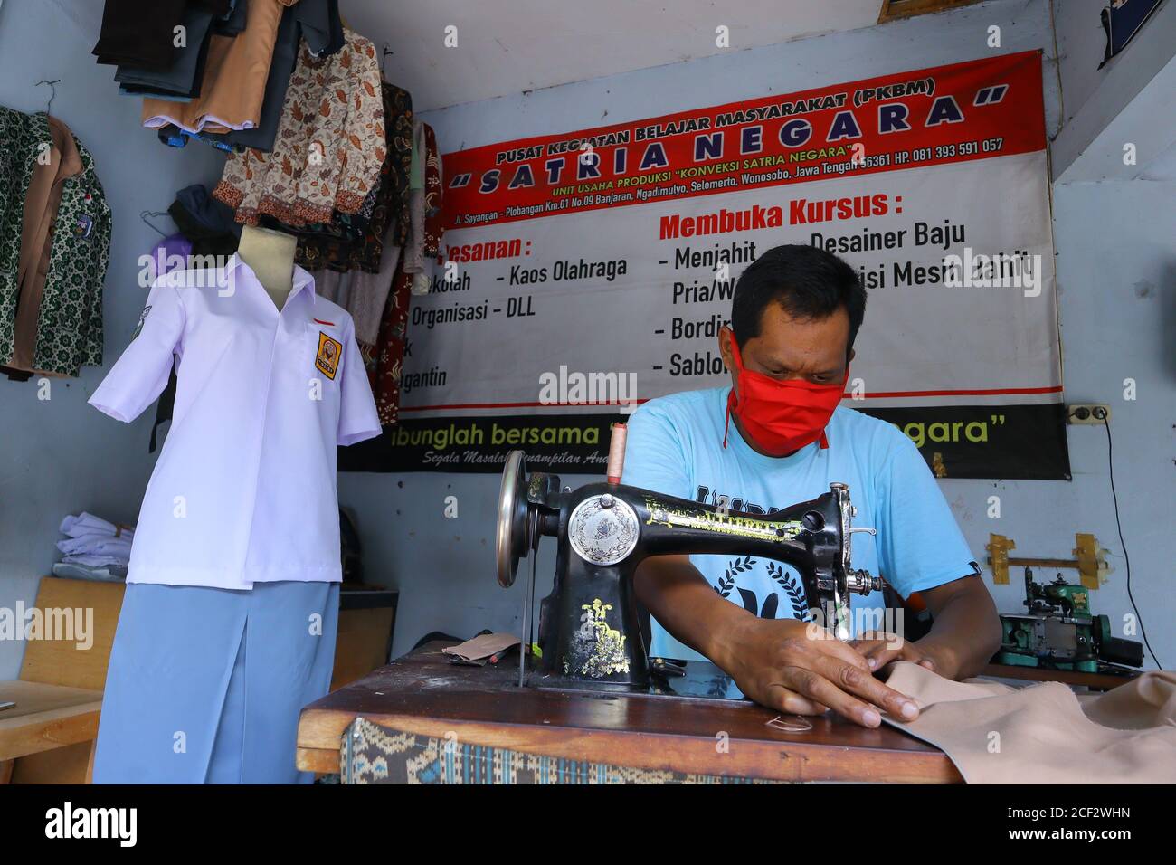 a photo of a tailor finishing his job Stock Photo