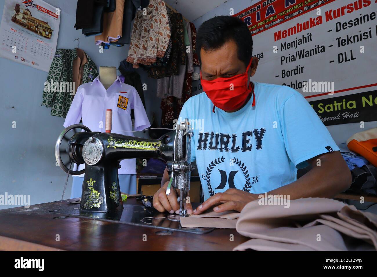 a photo of a tailor finishing his job Stock Photo - Alamy