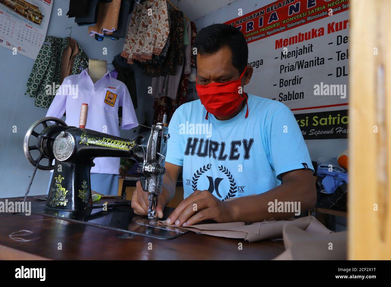 a photo of a tailor finishing his job Stock Photo