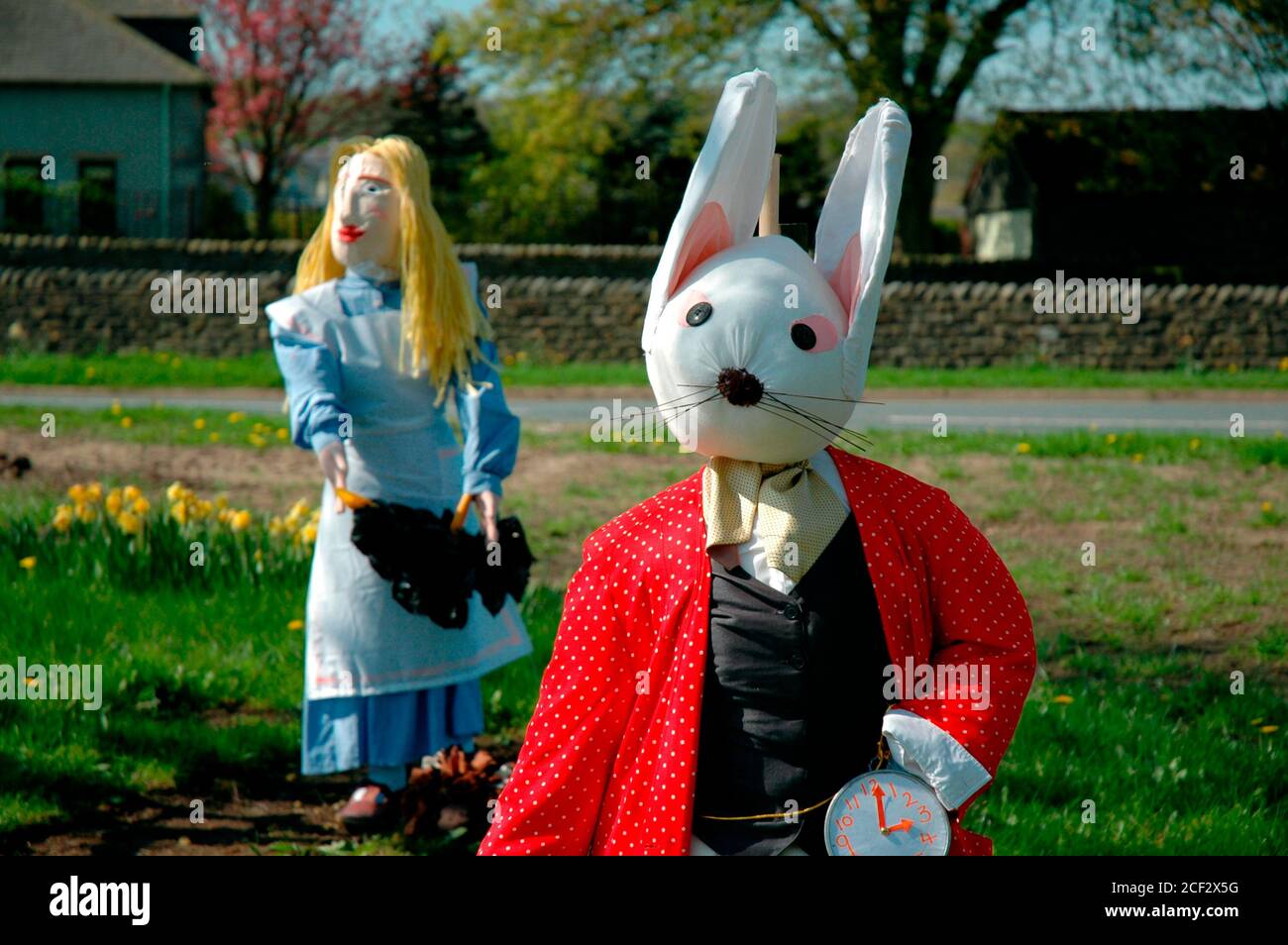 An exhibit at the Scarecrow Festival held annually at the village of Wray, near Lancaster, UK. Alice and the White Rabbit from Alice in Wonderland. Stock Photo