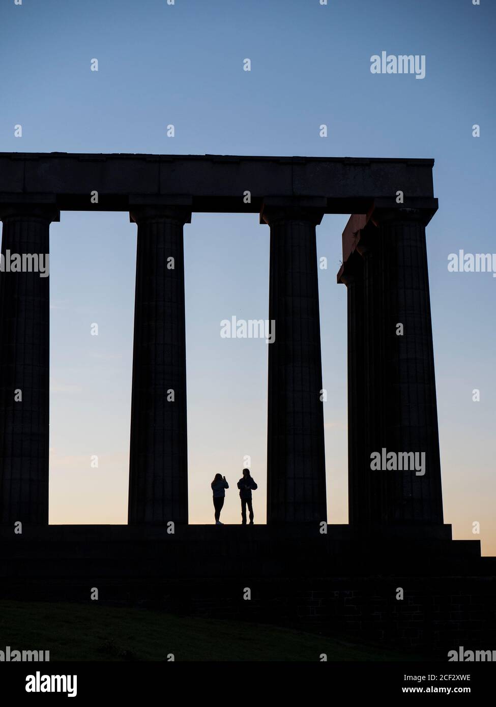Silhouette of two Teenagers, National Monument of Scotland, Edinburgh, Scotland, UK, GB. Stock Photo
