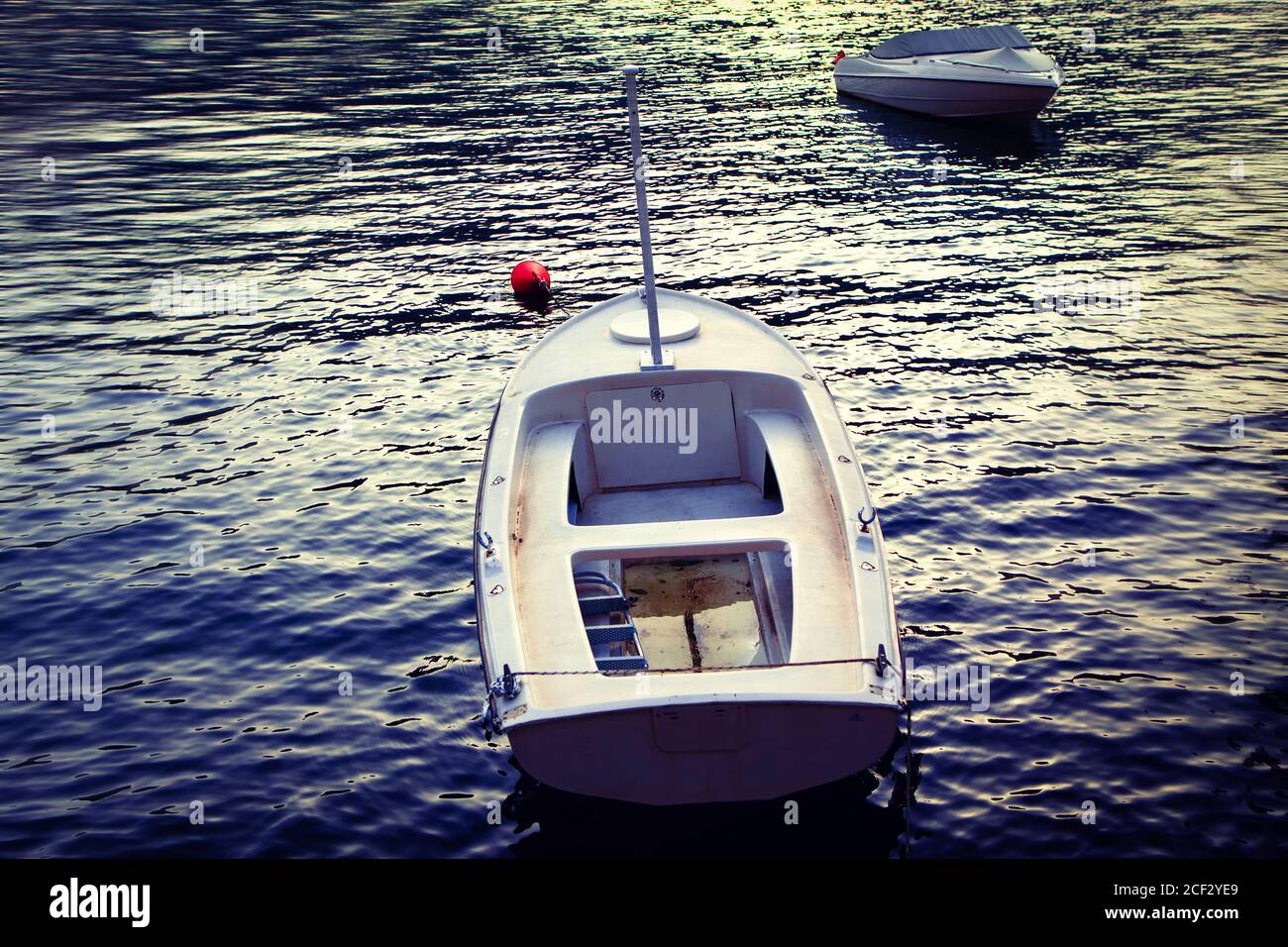 Empty boats in the twilight . Two moored white boats Stock Photo Alamy