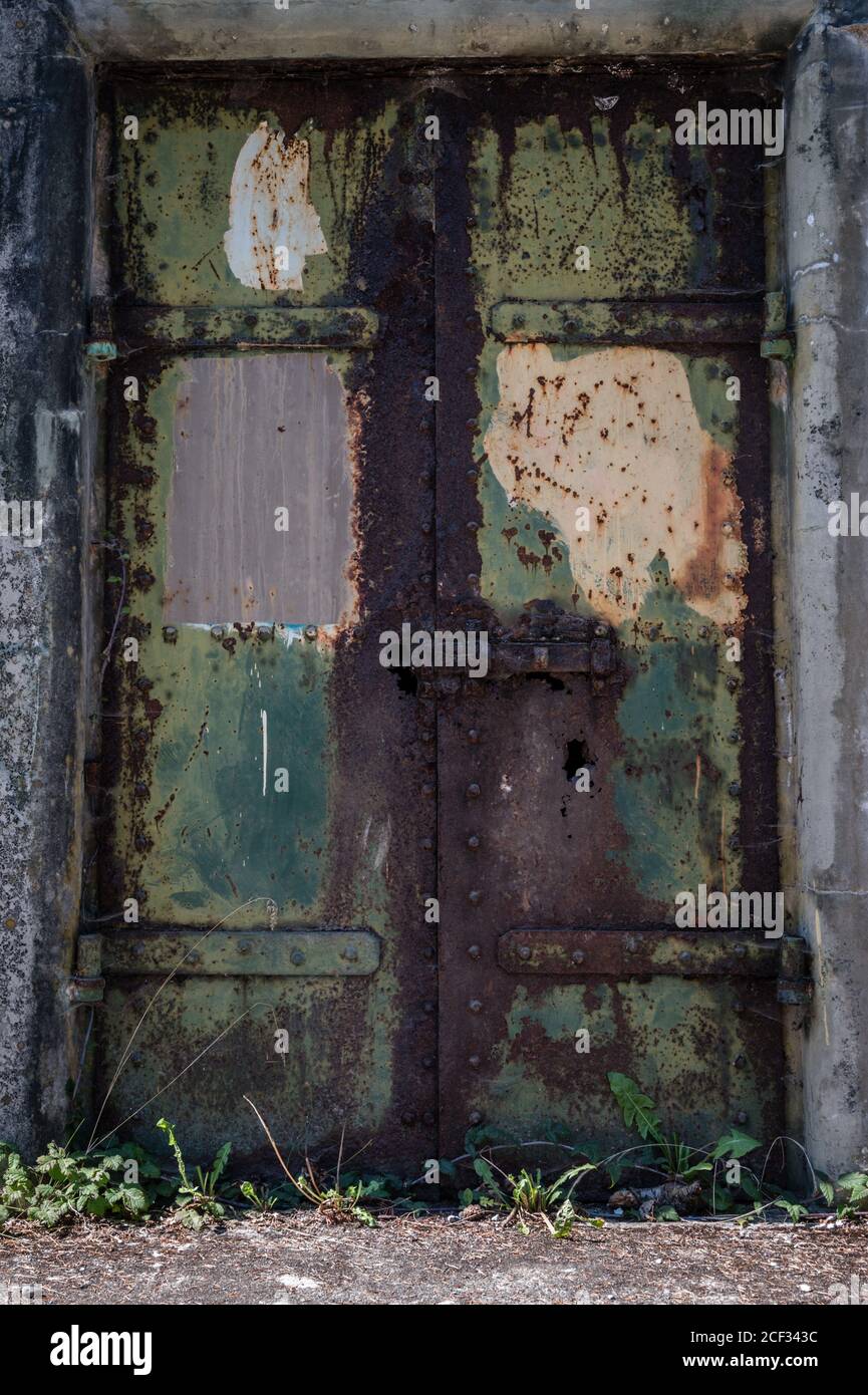 Rusty rustic metal door with green and yellow paint Stock Photo Alamy