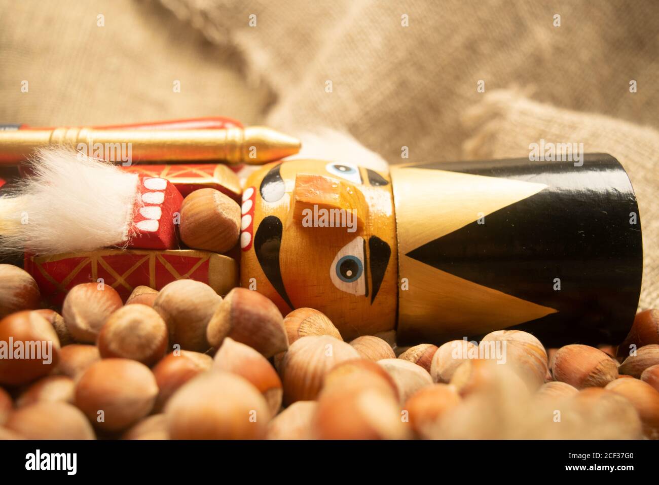 Nutcracker wooden figure of a soldier for cracking nuts on the background of scattered nuts