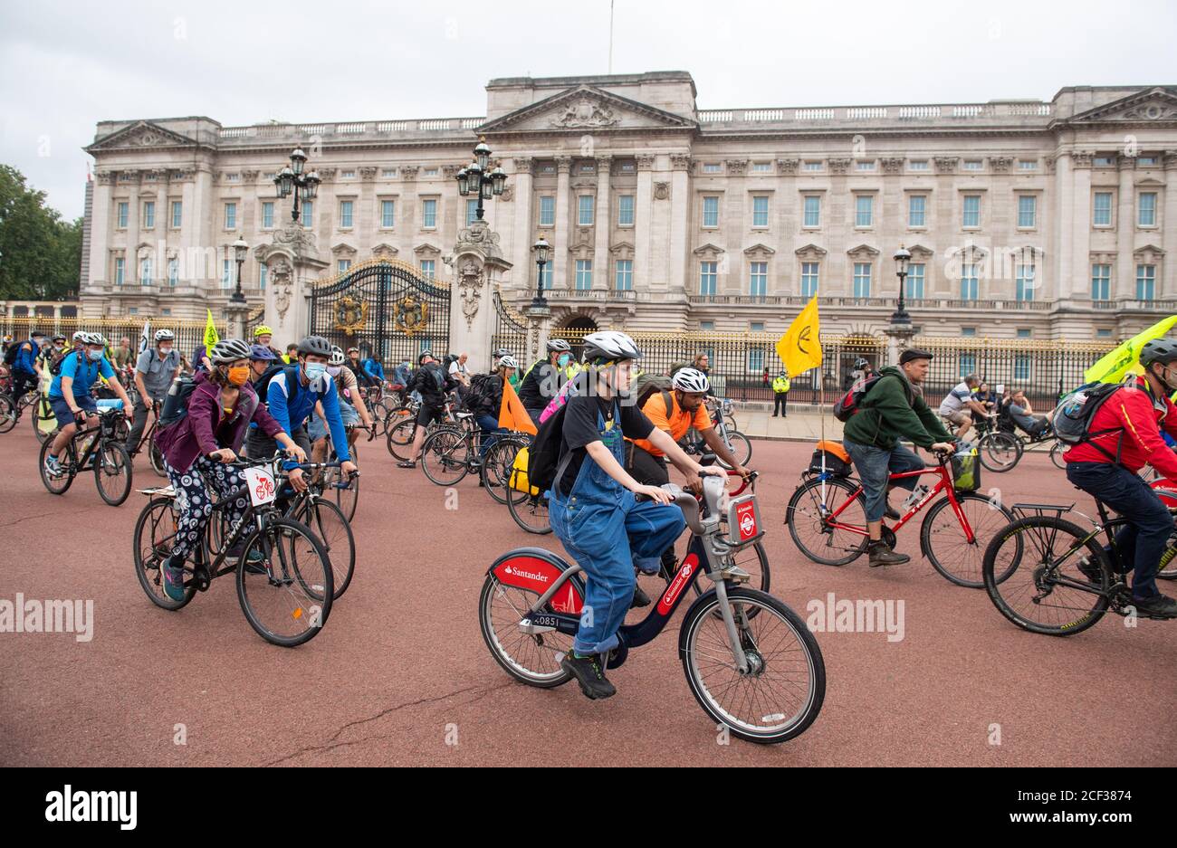 Cyclists set off from outside Buckingham Palace during an Extinction Rebellion protest in London. The environmental campaign group has planned events to be held at several landmarks in the capital. Stock Photo