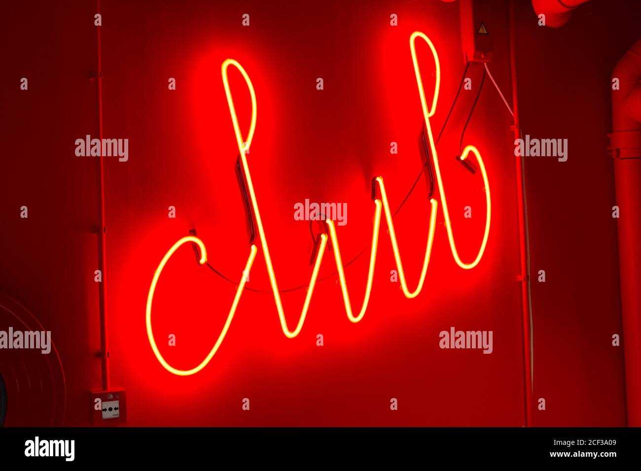 'Club' red sign with neon light on a wall Stock Photo