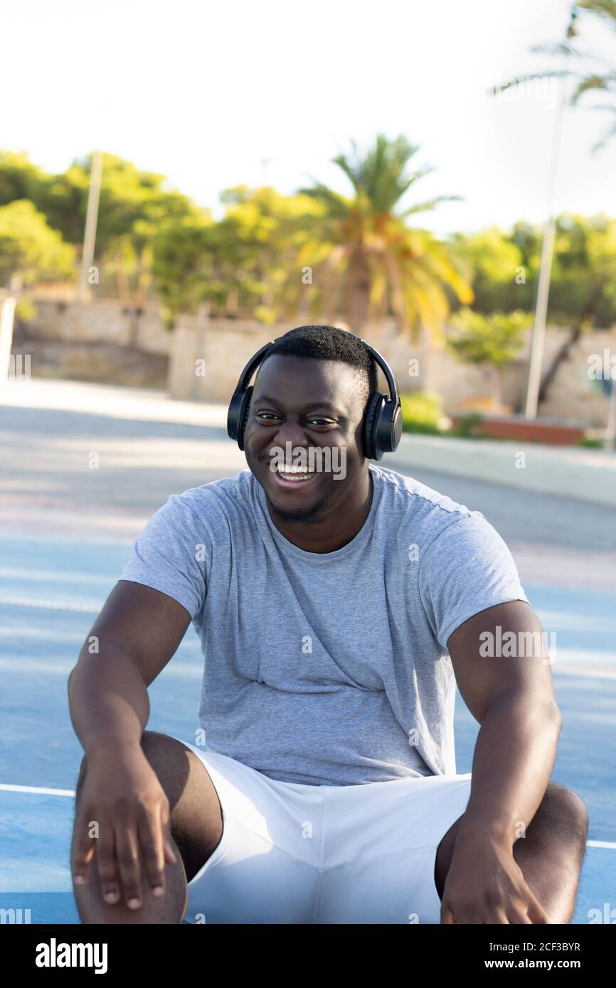 Young black man smiling and wearing headphones Stock Photo