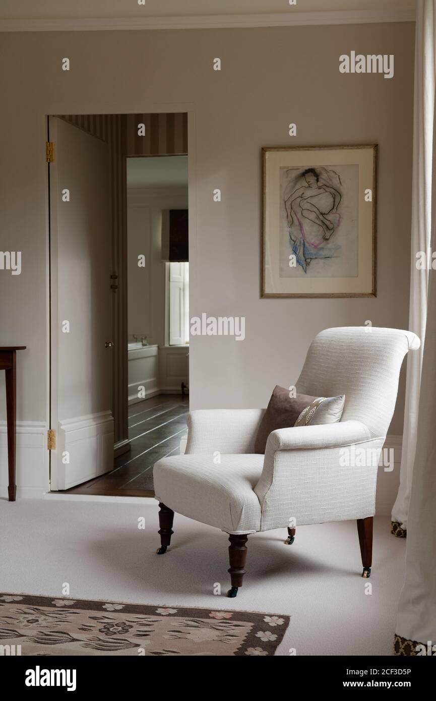 Armchair by open door in bedroom Stock Photo